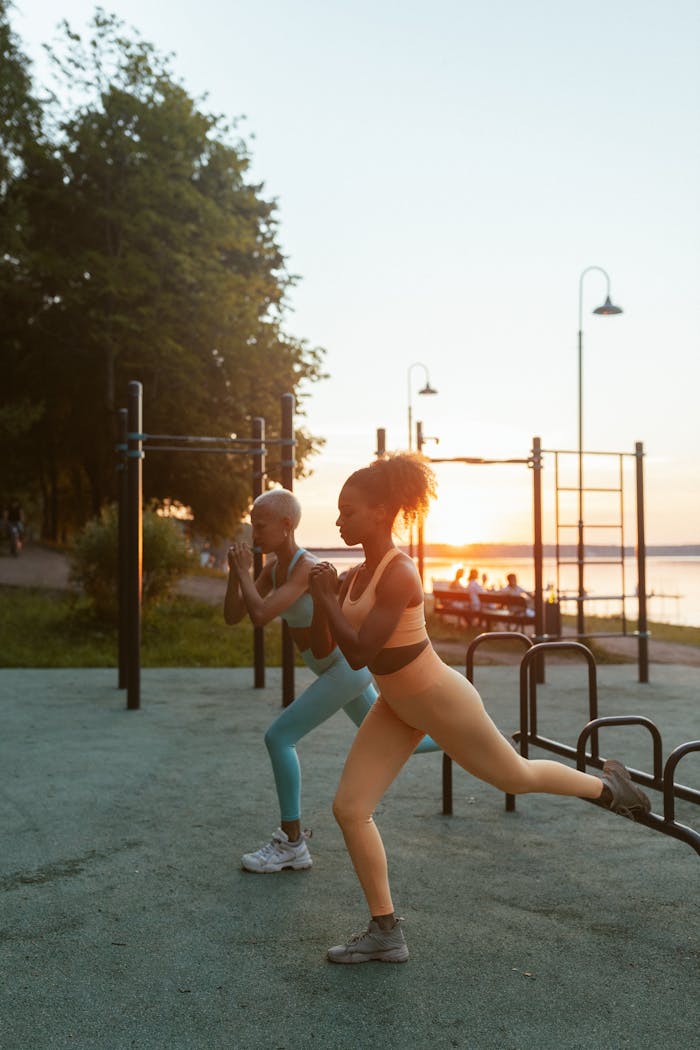 Mastering the First Impression: Your intriguing post title goes here Two women exercising outdoors at sunset, demonstrating fitness and health.